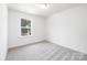 Well-lit, carpeted bedroom featuring bright natural light and neutral tones at 1124 Thayer Glen Ct, Charlotte, NC 28213