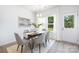 Bright dining room features modern decor, a dining table and natural light from the window at 1124 Thayer Glen Ct, Charlotte, NC 28213