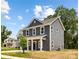 Gray two-story home with white trim and a cozy front porch, nestled in a growing neighborhood at 1124 Thayer Glen Ct, Charlotte, NC 28213