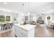 Modern kitchen with white cabinets, quartz countertops, stainless steel appliances, and a large island at 1124 Thayer Glen Ct, Charlotte, NC 28213