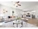 Spacious living room with hardwood floors, neutral decor, and an open layout connecting to the kitchen at 1124 Thayer Glen Ct, Charlotte, NC 28213