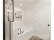 Modern bathroom boasts a separate tub and shower, marble-look tiling, and sleek black fixtures at 1132 Thayer Glen Ct, Charlotte, NC 28213