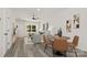 Open-concept living area with dining space features wood-look flooring, natural light, and views into the living room and kitchen at 1132 Thayer Glen Ct, Charlotte, NC 28213