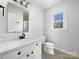 Updated bathroom with white vanity and quartz countertop at 11430 Gelding Dr, Charlotte, NC 28215