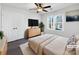Virtually staged bedroom with modern dresser and ceiling fan at 11430 Gelding Dr, Charlotte, NC 28215