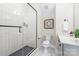Modern bathroom with gray shower, white tiled walls, and sleek black fixtures at 115 Verbena Ne St # 12, Charlotte, NC 28217