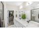 This sleek bathroom features a double vanity, walk-in shower, and closet at 115 Verbena Ne St # 12, Charlotte, NC 28217