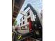Construction of a new three-story home shows structural work being done by a crane at 115 Verbena Ne St # 12, Charlotte, NC 28217
