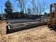 Construction site with a new foundation and equipment shown under a bright, clear sky at 115 Verbena Ne St # 12, Charlotte, NC 28217