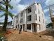 New construction three-story townhome showcases modern architecture with large windows and durable exterior materials at 115 Verbena Ne St # 12, Charlotte, NC 28217