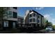 Modern townhomes with sleek gray and black exterior, stylish architecture, and ample parking at 115 Verbena Ne St # 12, Charlotte, NC 28217