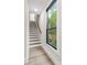 Hallway with wooden floor and stairs with a large window providing natural light at 115 Verbena Ne St # 12, Charlotte, NC 28217