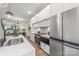 This modern kitchen features stainless appliances, stone counters, and sleek white cabinets at 115 Verbena Ne St # 12, Charlotte, NC 28217