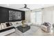 Comfortable living room featuring an oversized sofa, large window, ceiling fan and stylish decor at 115 Verbena Ne St # 12, Charlotte, NC 28217