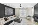 Modern living room featuring a comfortable white sofa, a large gray coffee table, and a stunning wall art piece at 115 Verbena Ne St # 12, Charlotte, NC 28217