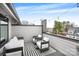 Outdoor patio with stylish seating and overhead string lights, perfect for relaxing and entertaining in style at 115 Verbena Ne St # 12, Charlotte, NC 28217