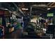 Large recreation area featuring modern arcade games, ample seating, and TV screens at 115 Verbena Ne St # 12, Charlotte, NC 28217