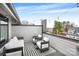 Stylish rooftop deck with outdoor seating and decorative string lights at 115 Verbena Ne St # 12, Charlotte, NC 28217