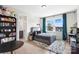 Cozy bedroom with gray bed and built in shelves at 13109 Brooklyn Skylar Way, Huntersville, NC 28078