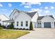 Two-story white house with gray garage door at 13109 Brooklyn Skylar Way, Huntersville, NC 28078
