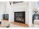 Elegant marble fireplace with a modern gas insert and sleek design at 13109 Brooklyn Skylar Way, Huntersville, NC 28078