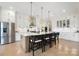 Modern kitchen with white cabinets, large island, and stainless steel appliances at 13109 Brooklyn Skylar Way, Huntersville, NC 28078