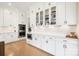 Modern kitchen with white cabinets, double oven, and herringbone backsplash at 13109 Brooklyn Skylar Way, Huntersville, NC 28078