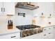 Modern kitchen with stainless steel gas cooktop and white herringbone tile backsplash at 13109 Brooklyn Skylar Way, Huntersville, NC 28078