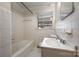 Bathroom with a bathtub, window, tile and single sink at 1438 Waddell St, Charlotte, NC 28216