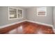 Bedroom featuring hardwood floors, two windows and neutral paint at 1438 Waddell St, Charlotte, NC 28216