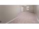 Large main bedroom with plush carpeting, ceiling fan, and attached closet at 1438 Waddell St, Charlotte, NC 28216