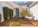 Inviting home entrance with bench seating and manicured greenery at 145 Jacobs Woods Cir, Troutman, NC 28166