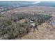 Aerial view of property with lake access and multiple outbuildings at 1745 Badin Lake Rd, New London, NC 28127