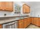 Modern kitchen with stainless steel appliances, granite countertops, wooden cabinets, and tiled floors at 1745 Badin Lake Rd, New London, NC 28127