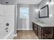 Clean bathroom with a bathtub/shower combo and dark brown vanity at 201 Ware St, Shelby, NC 28150