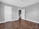 Bedroom with hardwood floors, gray walls, and staircase view at 201 Ware St, Shelby, NC 28150