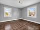 Hardwood floor bedroom with gray walls and two windows at 201 Ware St, Shelby, NC 28150
