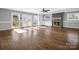 Sunlit living room with hardwood floors, fireplace, and French doors at 201 Ware St, Shelby, NC 28150