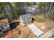 An aerial view of a quaint two-story home showcasing its charming exterior, long driveway, and well-maintained surroundings at 2204 Hillcrest Ave, Albemarle, NC 28001