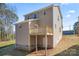Two-story home with deck that leads to a basement door nestled in a grassy backyard at 2204 Hillcrest Ave, Albemarle, NC 28001