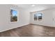 Sun-filled bedroom features hardwood floors, neutral walls, and dual windows at 2204 Hillcrest Ave, Albemarle, NC 28001