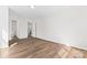 Empty bedroom showcasing neutral walls, vinyl floors, and a view to an ensuite bathroom at 2204 Hillcrest Ave, Albemarle, NC 28001
