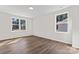 Bright bedroom featuring laminate flooring, two windows with natural light, and neutral colored walls at 2204 Hillcrest Ave, Albemarle, NC 28001