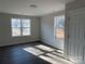 Bright bedroom with two windows providing natural light and modern dark flooring at 2204 Hillcrest Ave, Albemarle, NC 28001