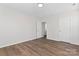 Bedroom with laminate flooring, natural light, neutral colored walls, and a closet at 2204 Hillcrest Ave, Albemarle, NC 28001
