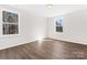 Large bedroom with laminate flooring, two windows with natural light, and neutral colored walls at 2204 Hillcrest Ave, Albemarle, NC 28001