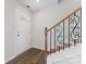 Inviting foyer showcasing hardwood floors, decorative stair railing, and a bright front door at 2204 Hillcrest Ave, Albemarle, NC 28001