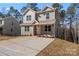 Charming two-story home with neutral siding and concrete driveway situated among mature trees at 2204 Hillcrest Ave, Albemarle, NC 28001