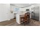 Eat-in kitchen features white cabinets, island with bar stool seating, and stainless appliances at 2204 Hillcrest Ave, Albemarle, NC 28001