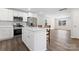 Modern kitchen with stainless steel appliances, an island, and hardwood floors at 2204 Hillcrest Ave, Albemarle, NC 28001